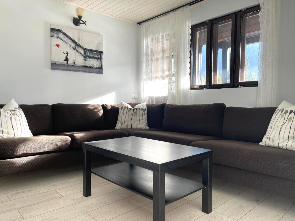 a living room with a couch and a coffee table at The Nest in Sinaia
