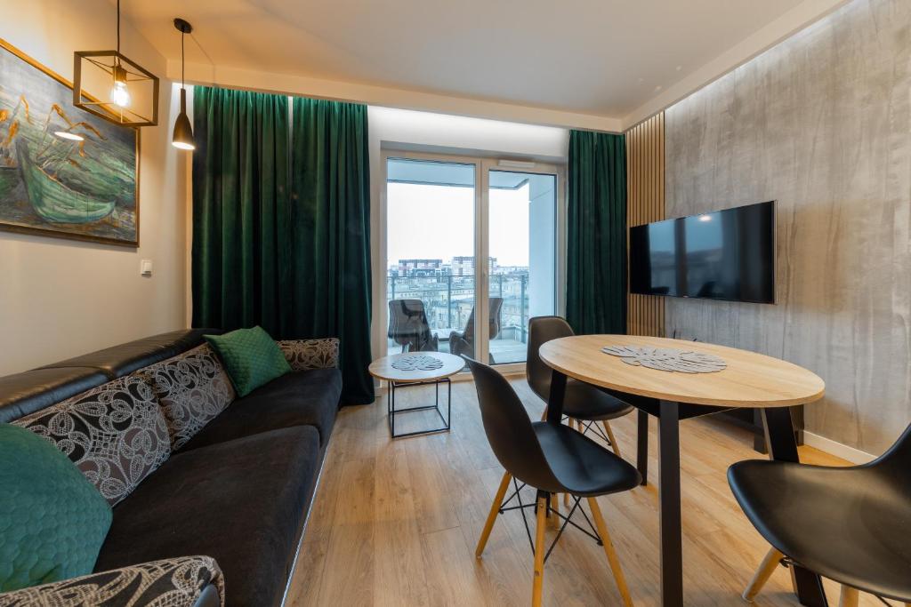 a living room with a couch and a table at Apartament Luxury Two-bedroom in Białystok