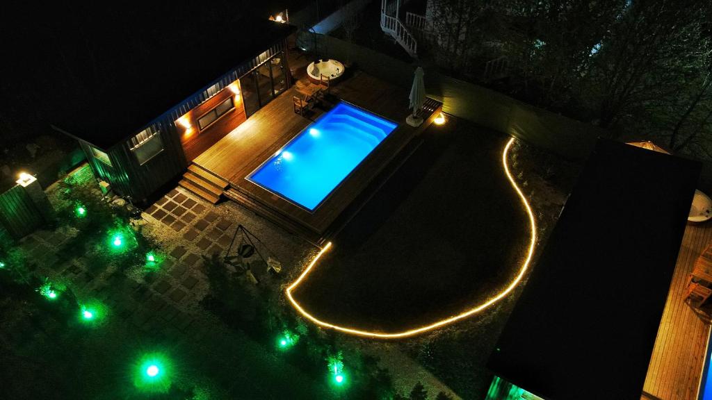 an overhead view of a swimming pool at night at Alley Tiny House in Fethiye