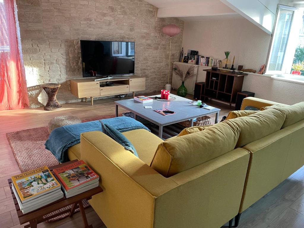 a living room with a couch and a table at Lovely apartment in Périgueux in Périgueux