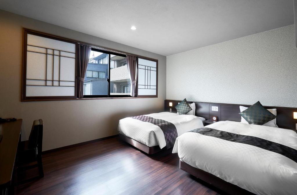 Postel nebo postele na pokoji v ubytování Hotel Kuu Kyoto