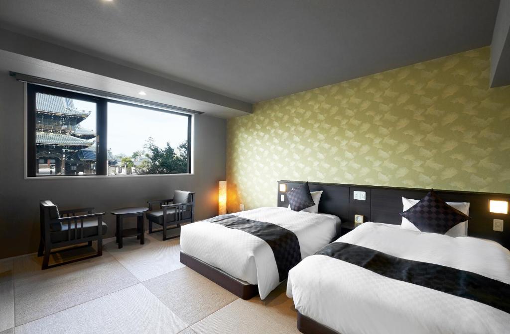 Postel nebo postele na pokoji v ubytování Hotel Kuu Kyoto