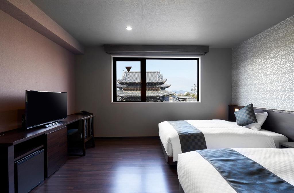 Postel nebo postele na pokoji v ubytování Hotel Kuu Kyoto
