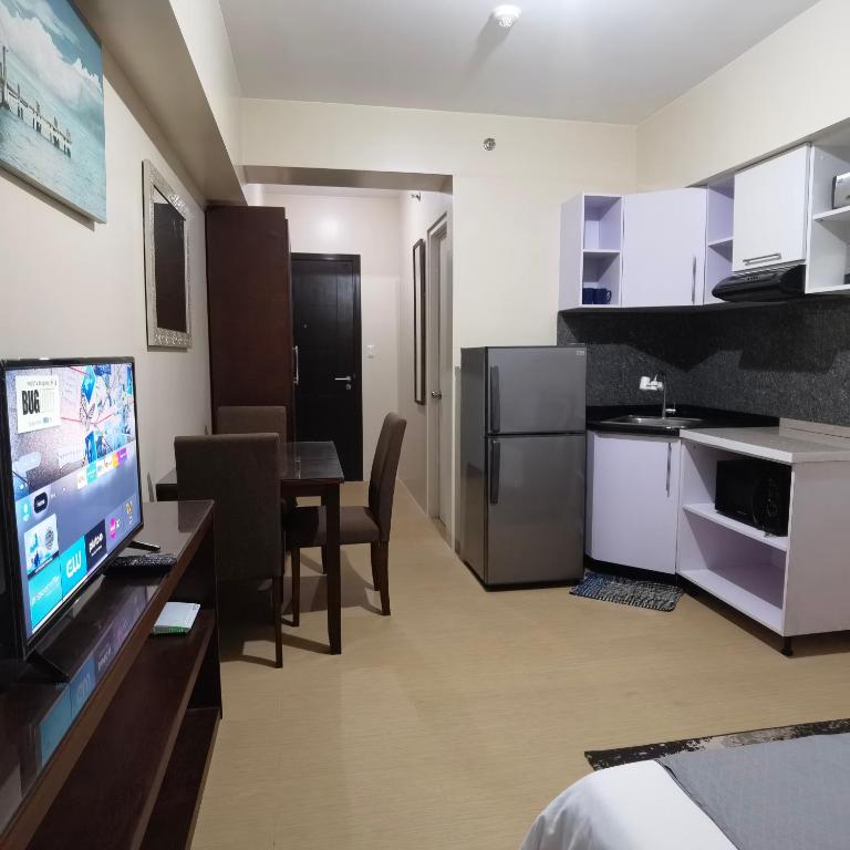 a room with a kitchen and a dining room at Avida Davao Condos, downtown CM Recto Avenue, Davao City in Davao City