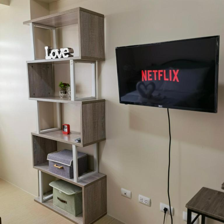 a flat screen tv hanging on a wall at Avida Davao Condos, downtown CM Recto Avenue, Davao City in Davao City