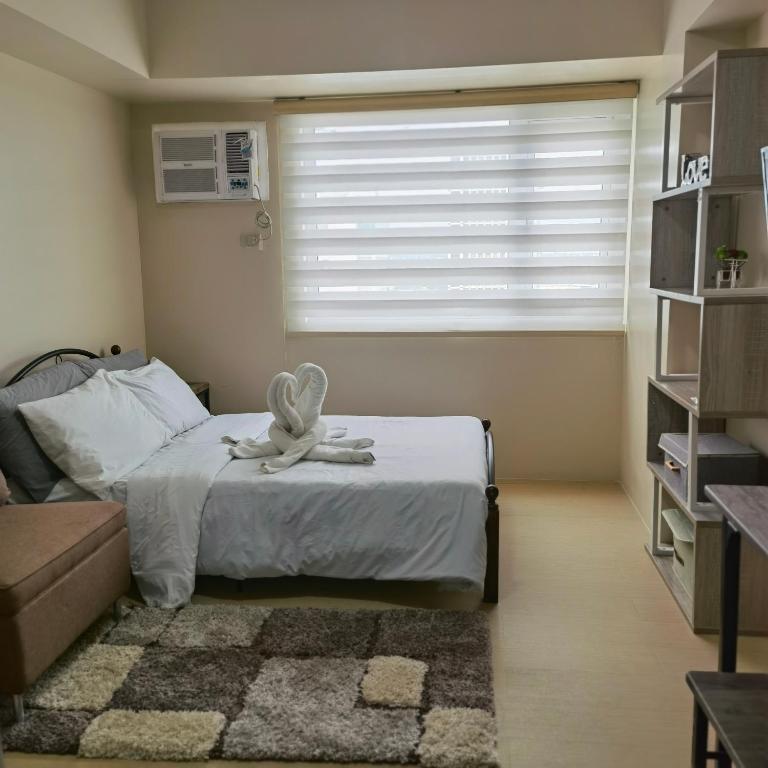 a bedroom with a bed with a towel on it at Avida Davao Condos, downtown CM Recto Avenue, Davao City in Davao City