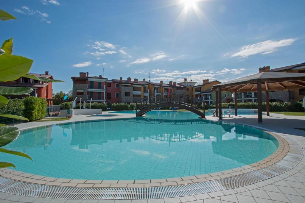 a large swimming pool in a courtyard with buildings at Appartamento Emerald in Sirmione
