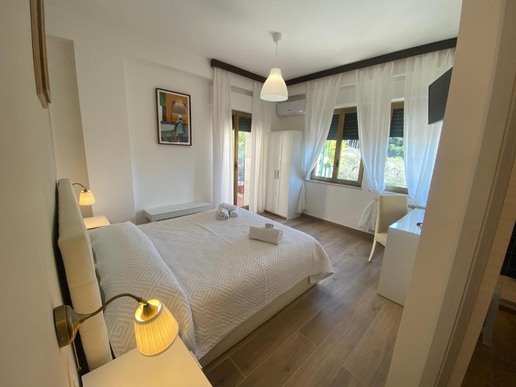 a bedroom with a bed and a table with a lamp at B&B Casa al Vicolo 2 in Taormina