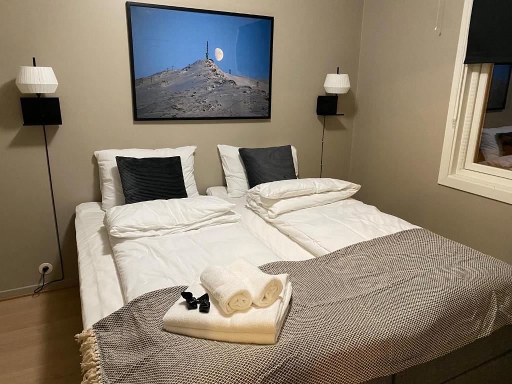 - 2 lits dans une chambre avec des draps blancs et des serviettes dans l'établissement Big central house, free parking, wifi, 3 bedrooms, à Narvik