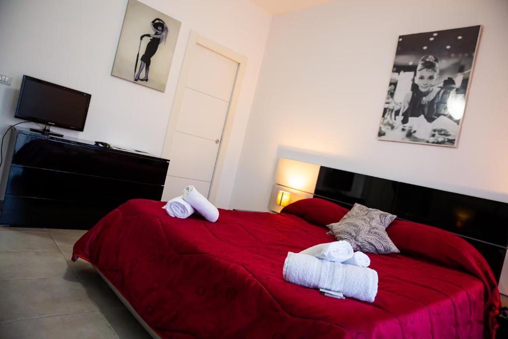 a bedroom with a bed and a dresser at Etna Catania Center in Catania
