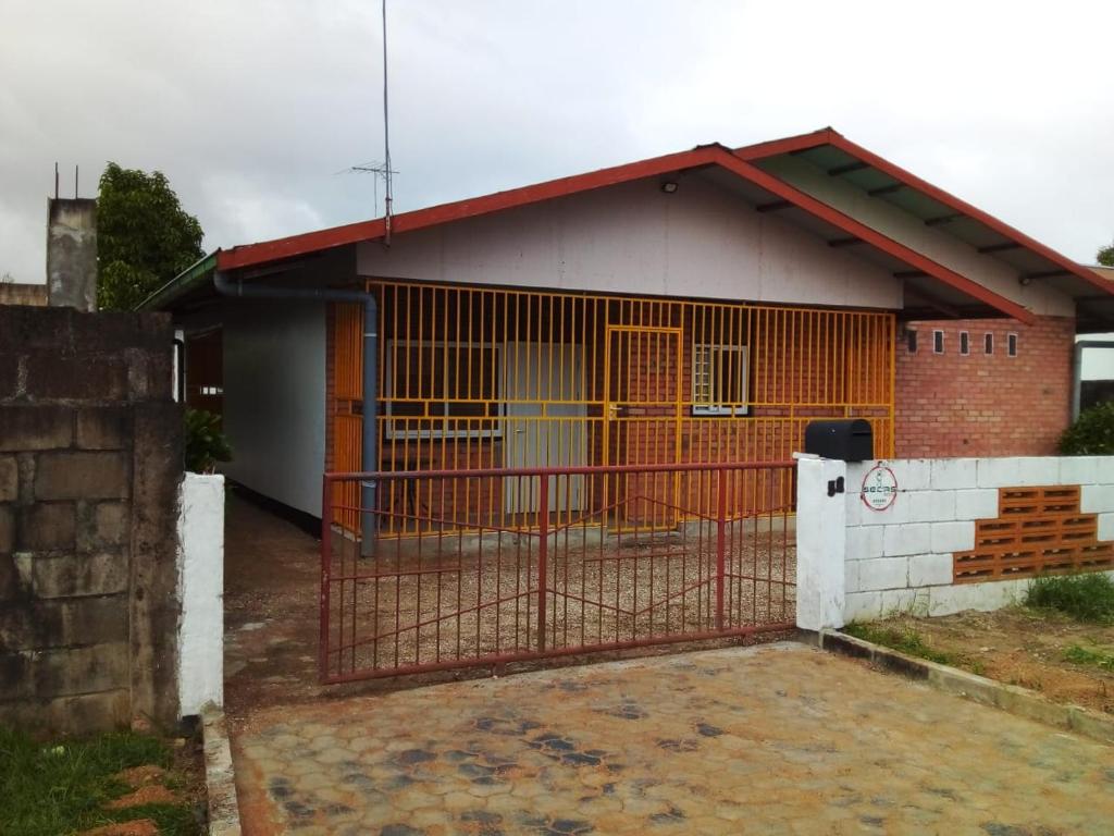 a house with a gate in front of it at 3 Bed House - Sleeps 4 - Parking - Wifi in Paramaribo