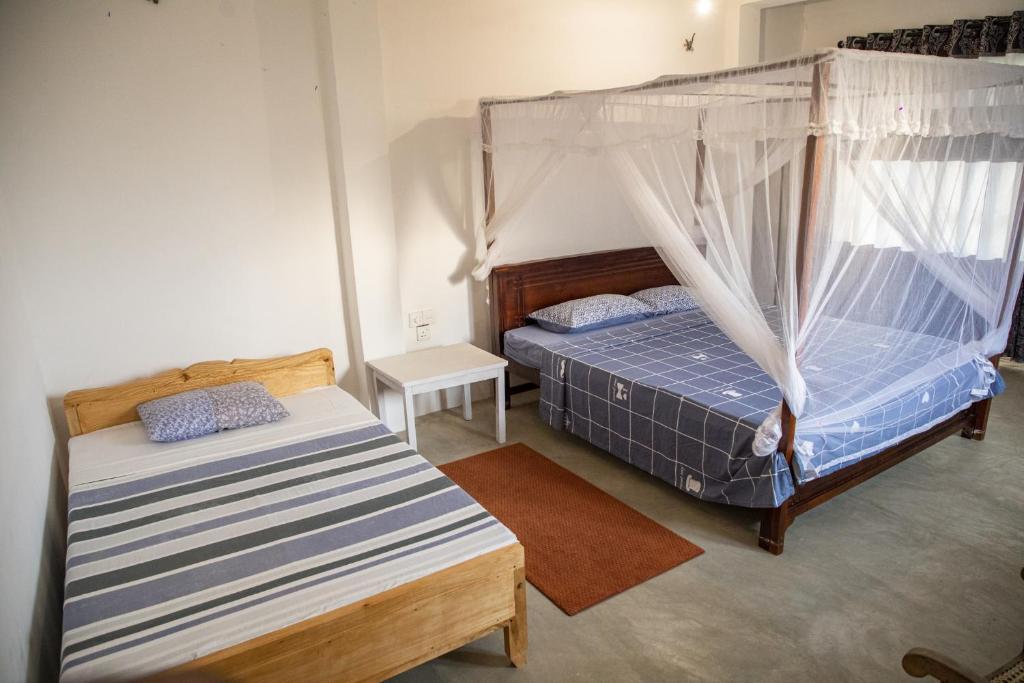 Postel nebo postele na pokoji v ubytování Kodi Beach Home
