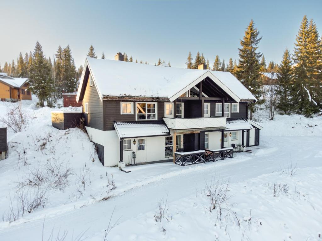 a house in the snow with snow covered trees at Nice apartment with Sauna and ski in out Trysil in Trysil