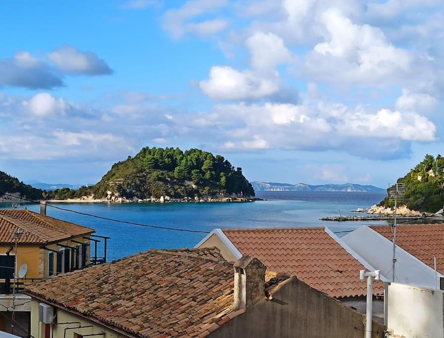 a view of a large body of water with houses at Dimitri's Seaview Studio - Lakka Paxos in Lákka