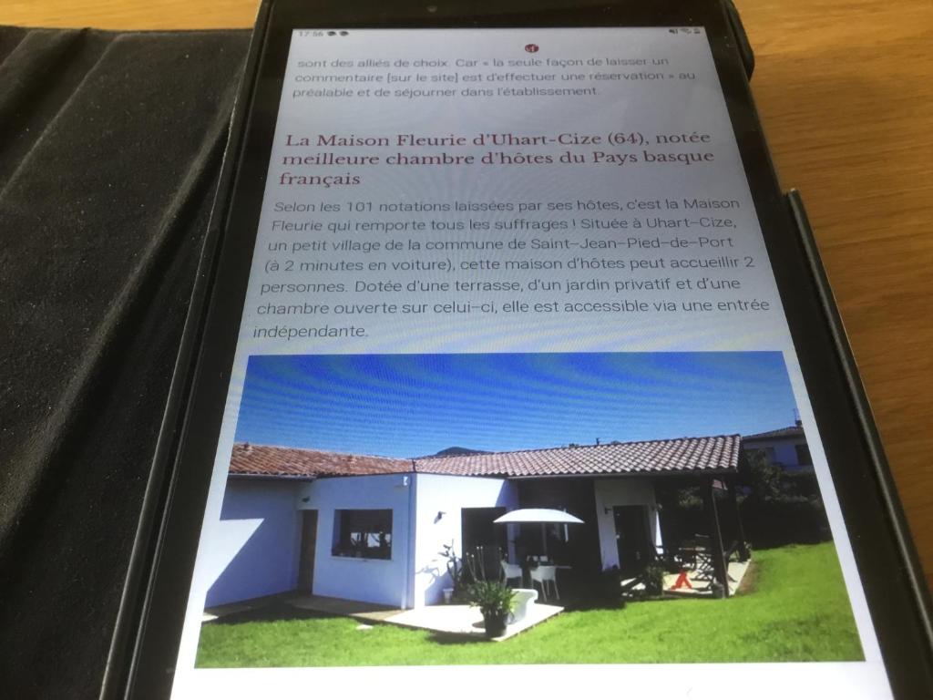 a book with a picture of a house at Maison Fleurie in Uhart-Cize