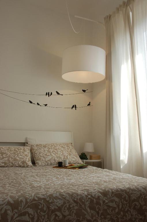 a bedroom with a bed with birds on the wall at Farina 14 in Florence