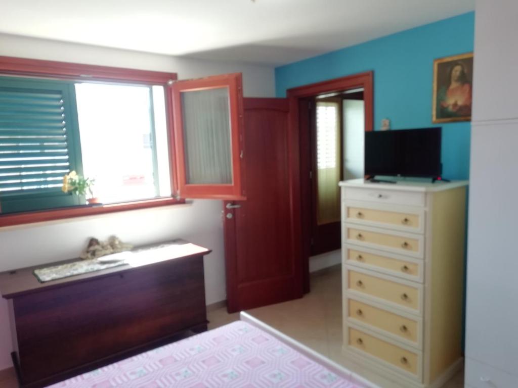 Postel nebo postele na pokoji v ubytování Specchia Terrazza&Tavernetta Arcobaleno
