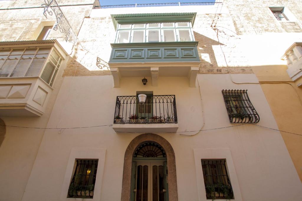 - un bâtiment avec un balcon et une fenêtre dans l'établissement Town house steeped in history, à Rabat