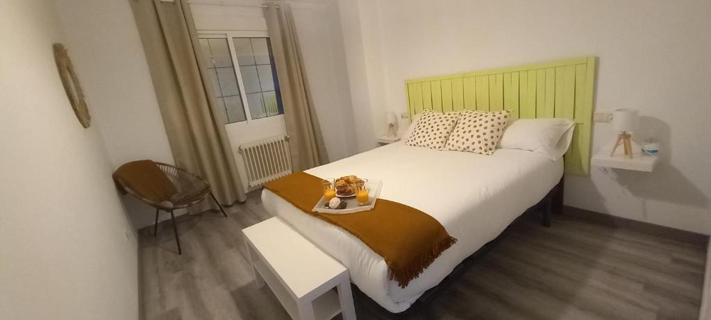 a bedroom with a large bed with a tray on it at Apartamento Exterior Camino Inglés # a 10 min de Santiago in Sigüeiro