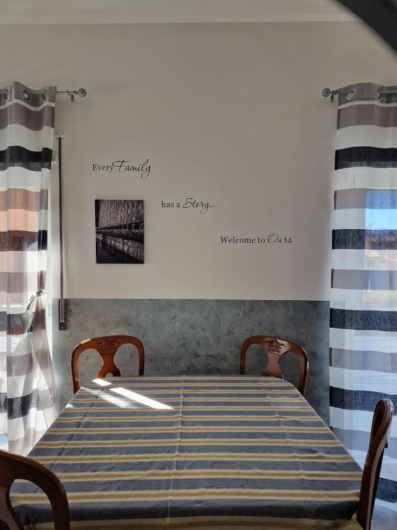 a dining room with a blue and white table and chairs at La casa azzurra in LʼAquila