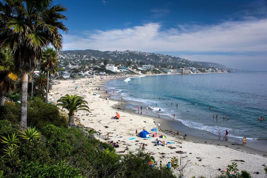 a beach with a lot of people and the ocean at Crescent Bay Inn in Laguna Beach