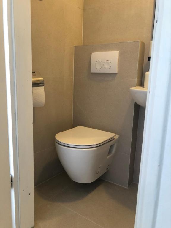 a small bathroom with a toilet and a sink at Guest House Marta in Rovinj