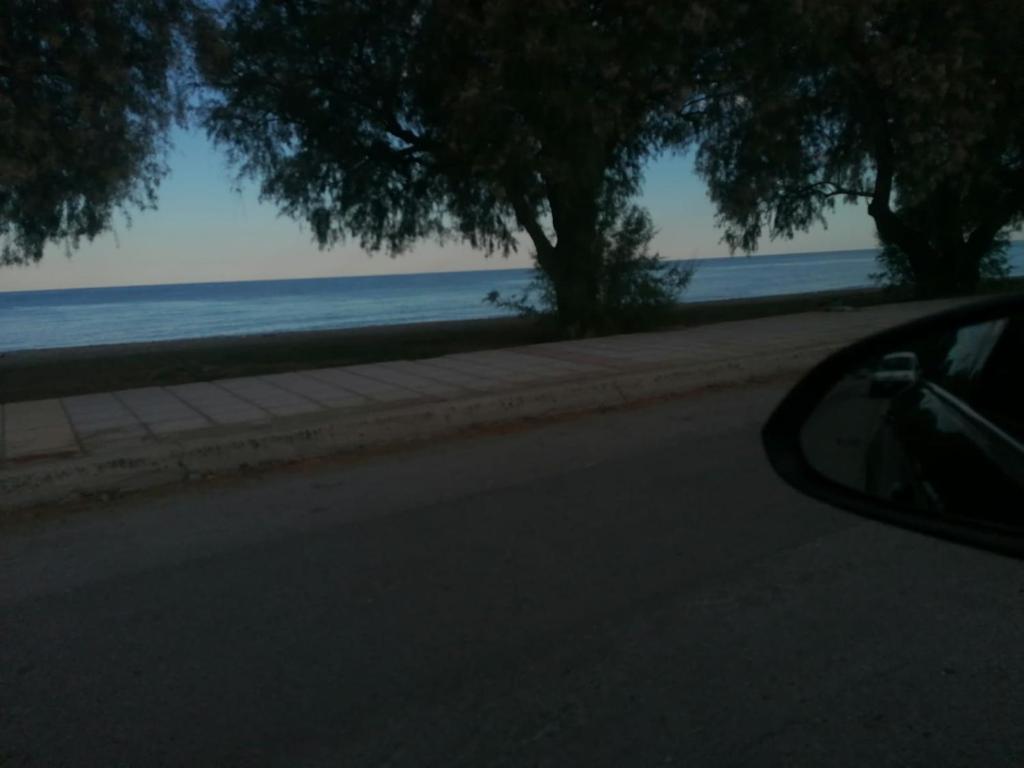 a view of the beach from the side of a car at ntinasvillage in Leptokarya