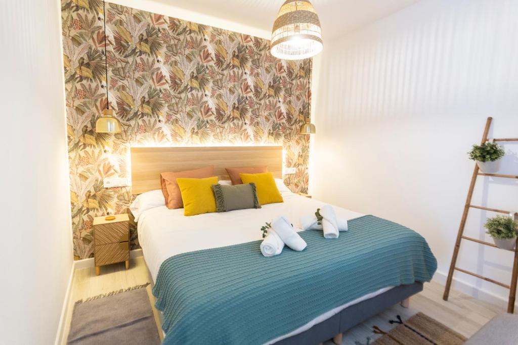 a bedroom with a bed with two stuffed animals on it at ENTREARCOS in Cádiz