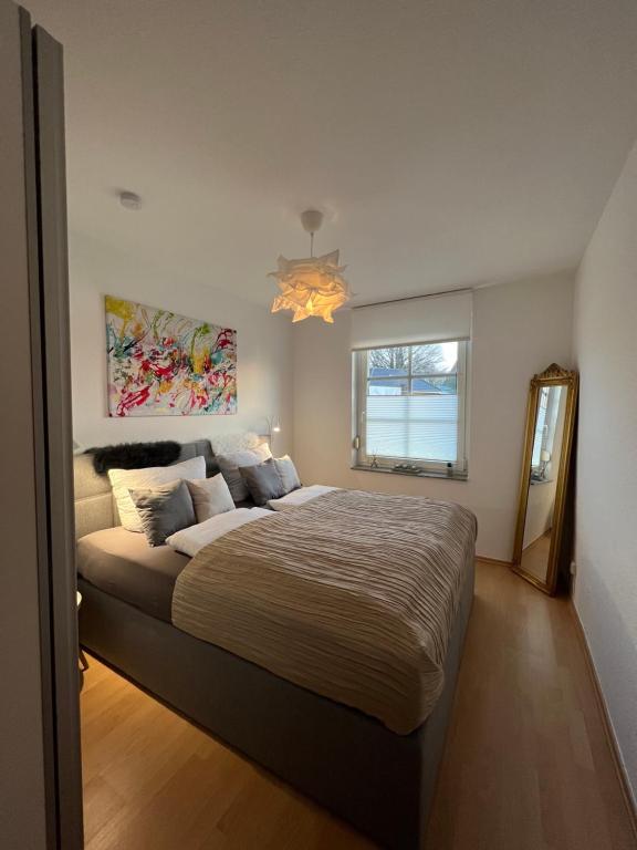 a bedroom with a large bed and a window at Wohnen im alten Amtsgericht im Herzen von Xanten in Xanten