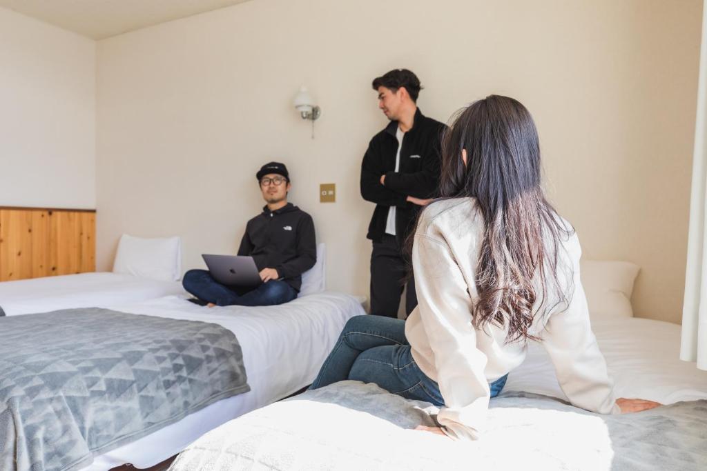 Postel nebo postele na pokoji v ubytování UNPLAN Village Hakuba