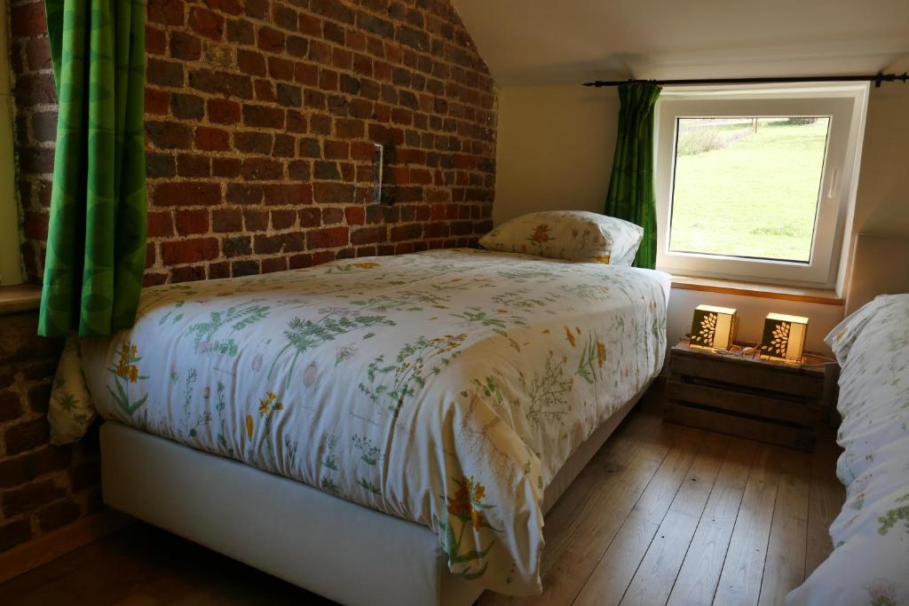 Postel nebo postele na pokoji v ubytování B&B La ferme de Berwausault