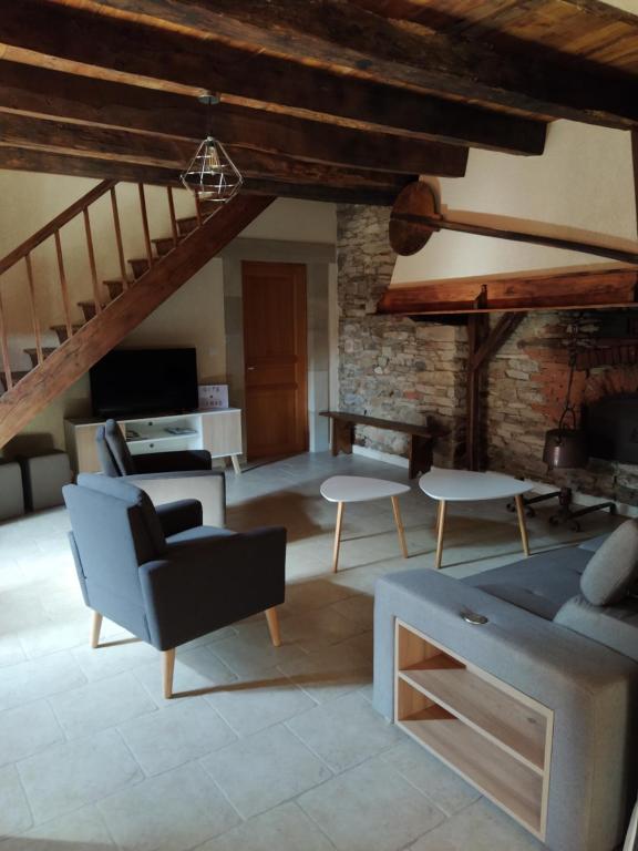 a living room with a couch and a table at Maison Céras in Lédergues