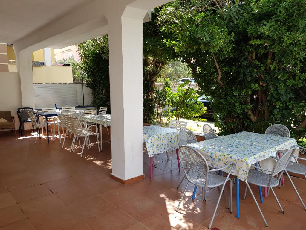 an outdoor patio with tables and chairs at PORTA NOVALIS Rooms in Novalja