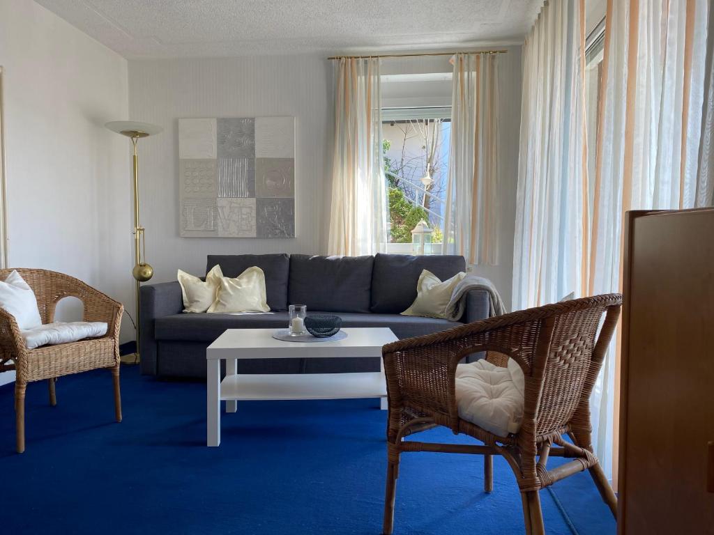 - un salon avec un canapé, une table et des chaises dans l'établissement Ferienwohnung im Vorbachtal, à Niederstetten