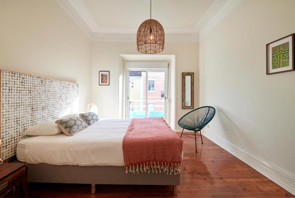 a bedroom with a bed and a pendant light at Quiet and Central 2BR APT, By TimeCooler in Lisbon