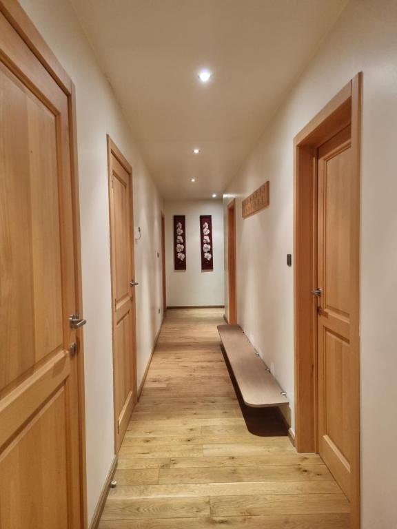 a hallway with wooden floors and two doors at SusBerg-1 & 2 in Neerpelt