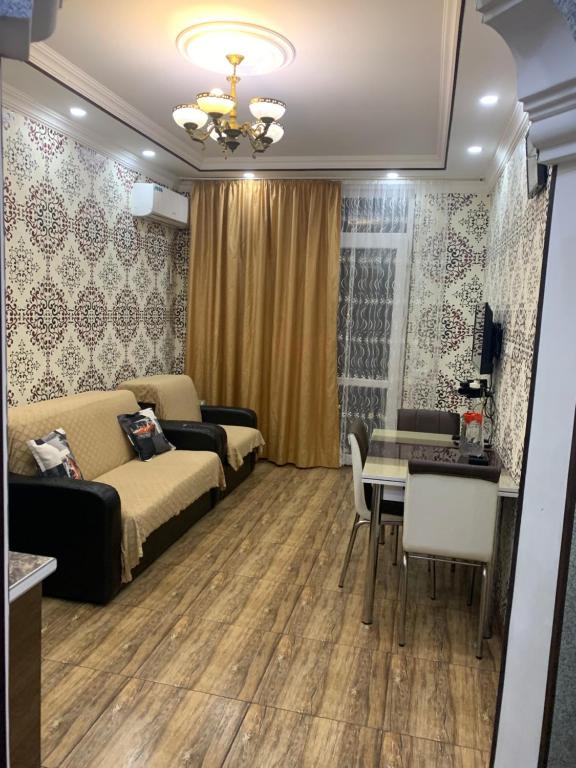 a living room with a couch and a table at Gorgasali street Apartment in Batumi