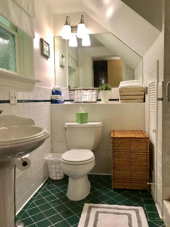 a bathroom with a white toilet and a sink at Parker Guest House in San Francisco