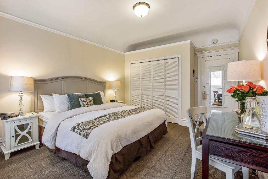 a bedroom with a large bed and a desk at Parker Guest House in San Francisco