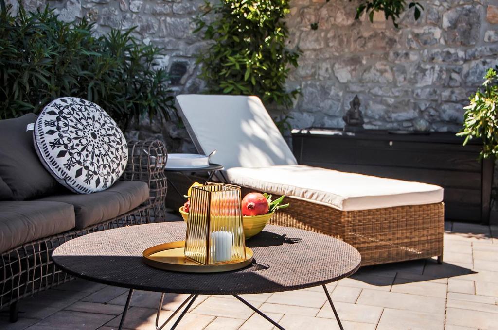 a table with a bowl of fruit on a patio at Luxury Villa Orh Rovinj in Rovinj