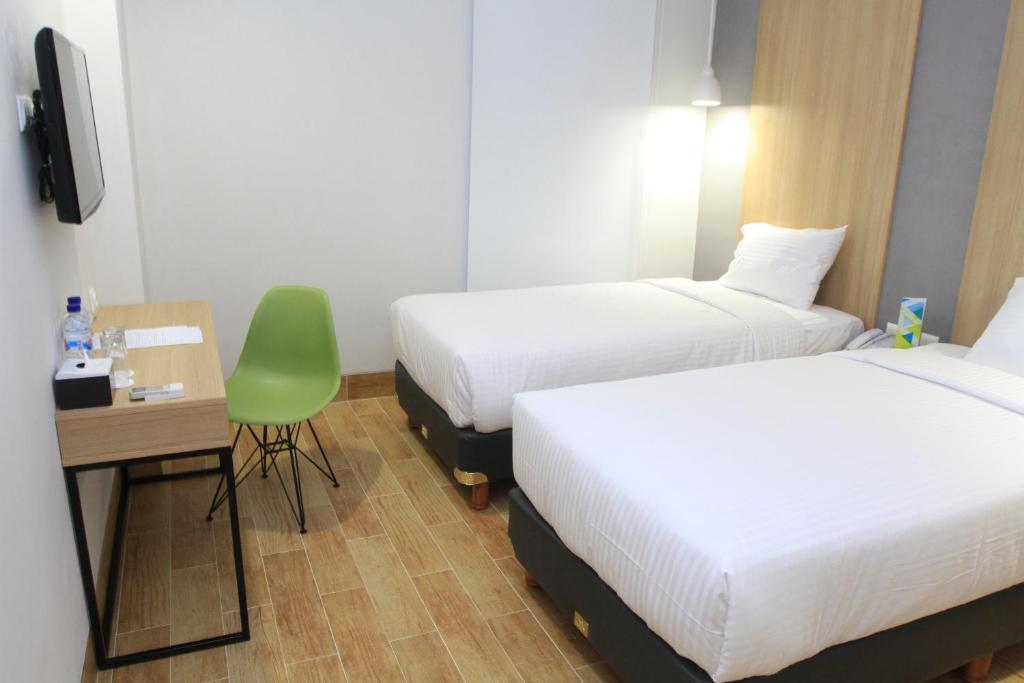 Postel nebo postele na pokoji v ubytování Hotel Citradream Semarang