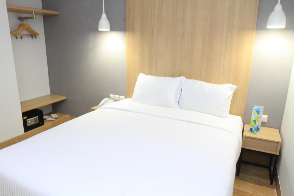 Postel nebo postele na pokoji v ubytování Hotel Citradream Semarang