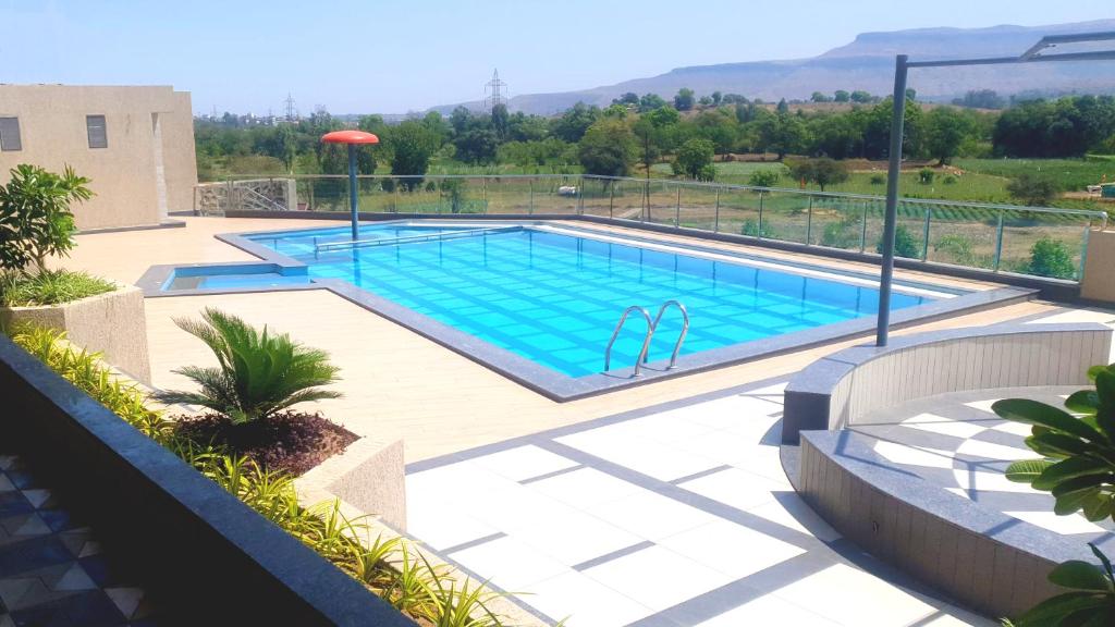 a swimming pool on top of a building at Hotel Grand Parivaar in Igatpuri