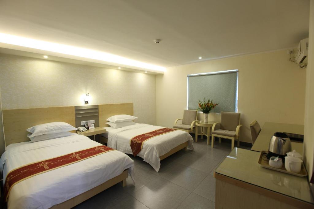 Postel nebo postele na pokoji v ubytování Guang Dong Hotel