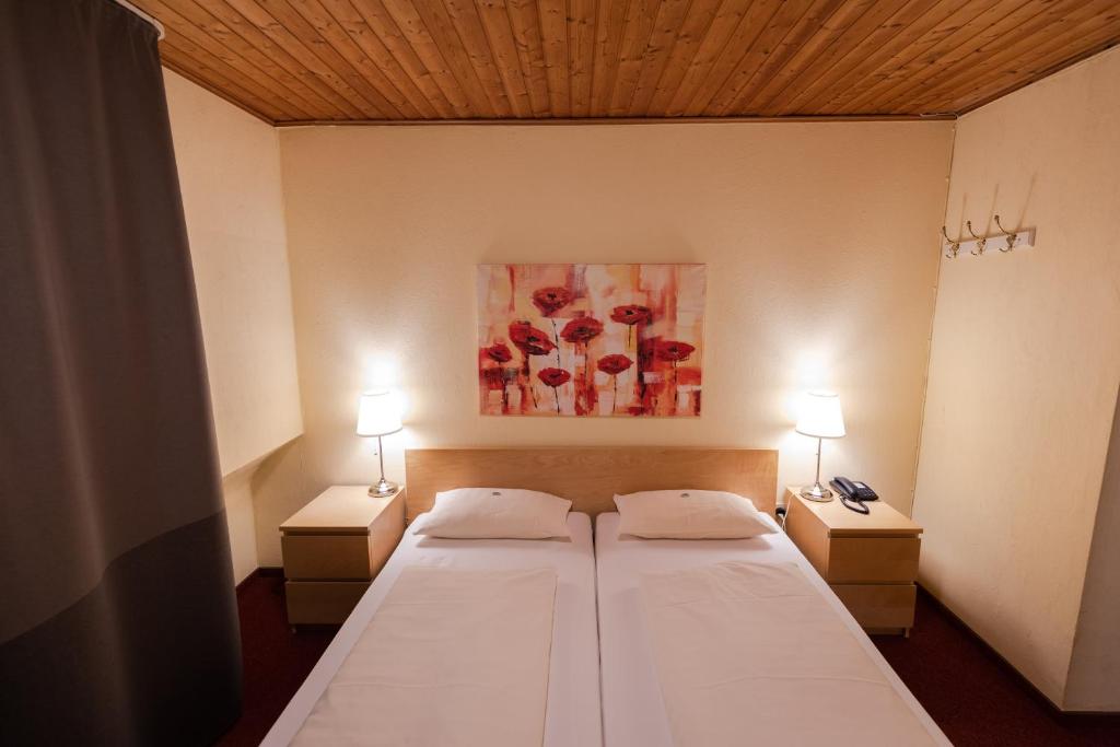 Postel nebo postele na pokoji v ubytování Landhotel Ewerts