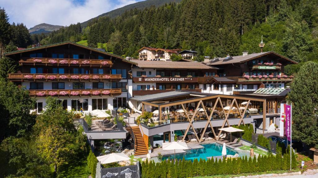 a hotel in the mountains with a swimming pool at Hotel Gassner - 4 Sterne Superior in Neukirchen am Großvenediger