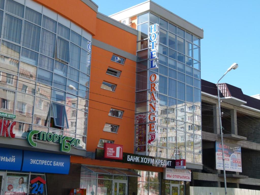 an orange building with a sign on it at Hotel Orange in Essentuki