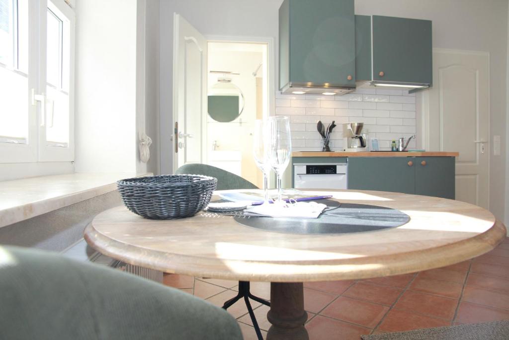 a kitchen with a wooden table with a wine glass at Villa Gudrun in Westerland