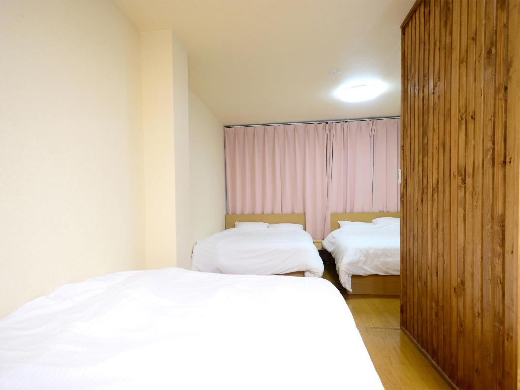 Postel nebo postele na pokoji v ubytování K's Hotel
