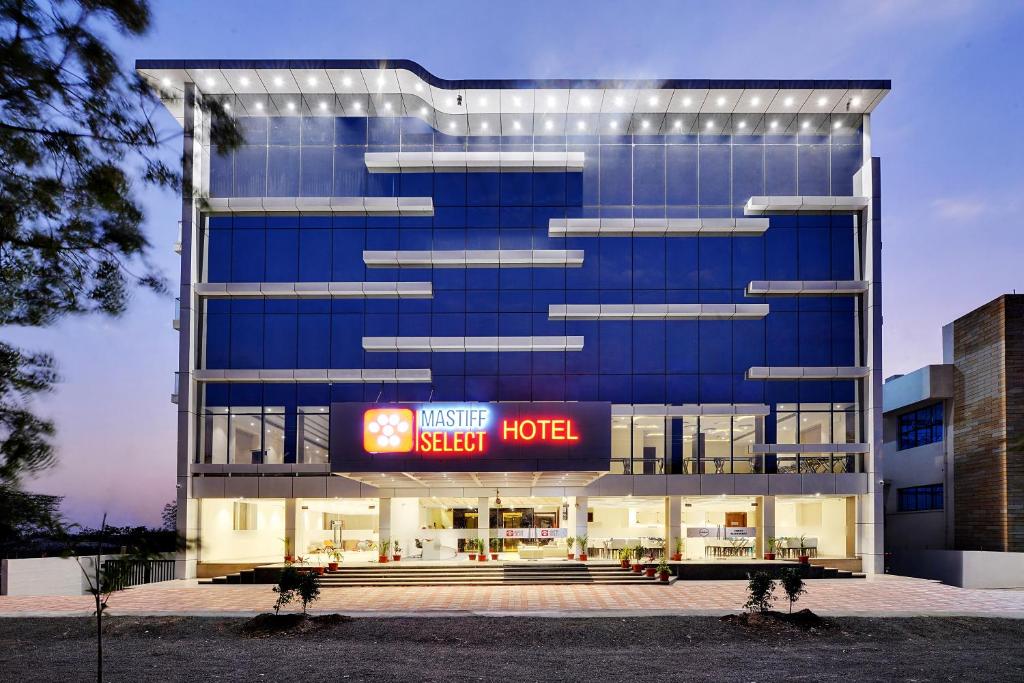 a building with a hotel sign in front of it at Mastiff Select Gulbarga in Gulbarga